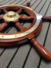 Close up of mahogany steering wheel spokes and brass decal