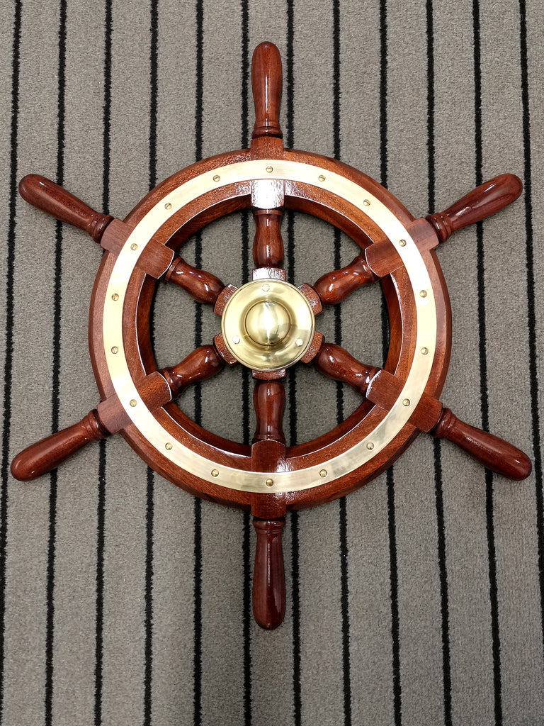 Mahogany steering wheel birds eye lying on striped carpet