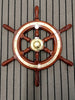 Mahogany steering wheel birds eye lying on striped carpet